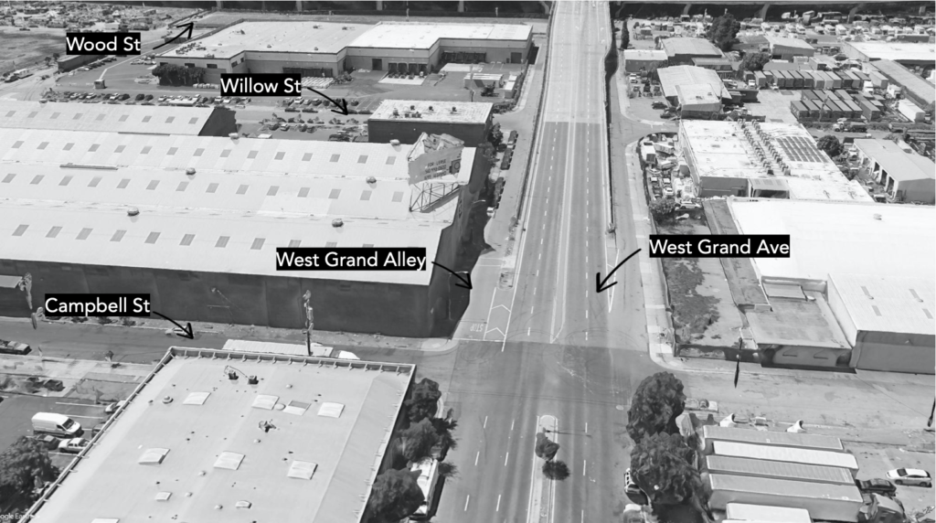 Black-and-white aerial photo of West Grand, showing West Grand Alley running alongside the freeway ramp.