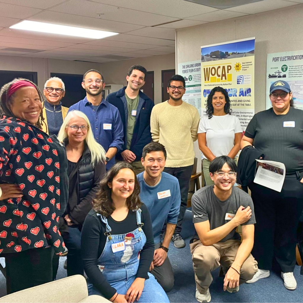 A group of people smiles for the camera at the WOEIP office